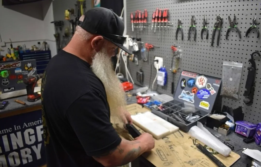 Magnet assembling an AR at the Lion Arms workbench